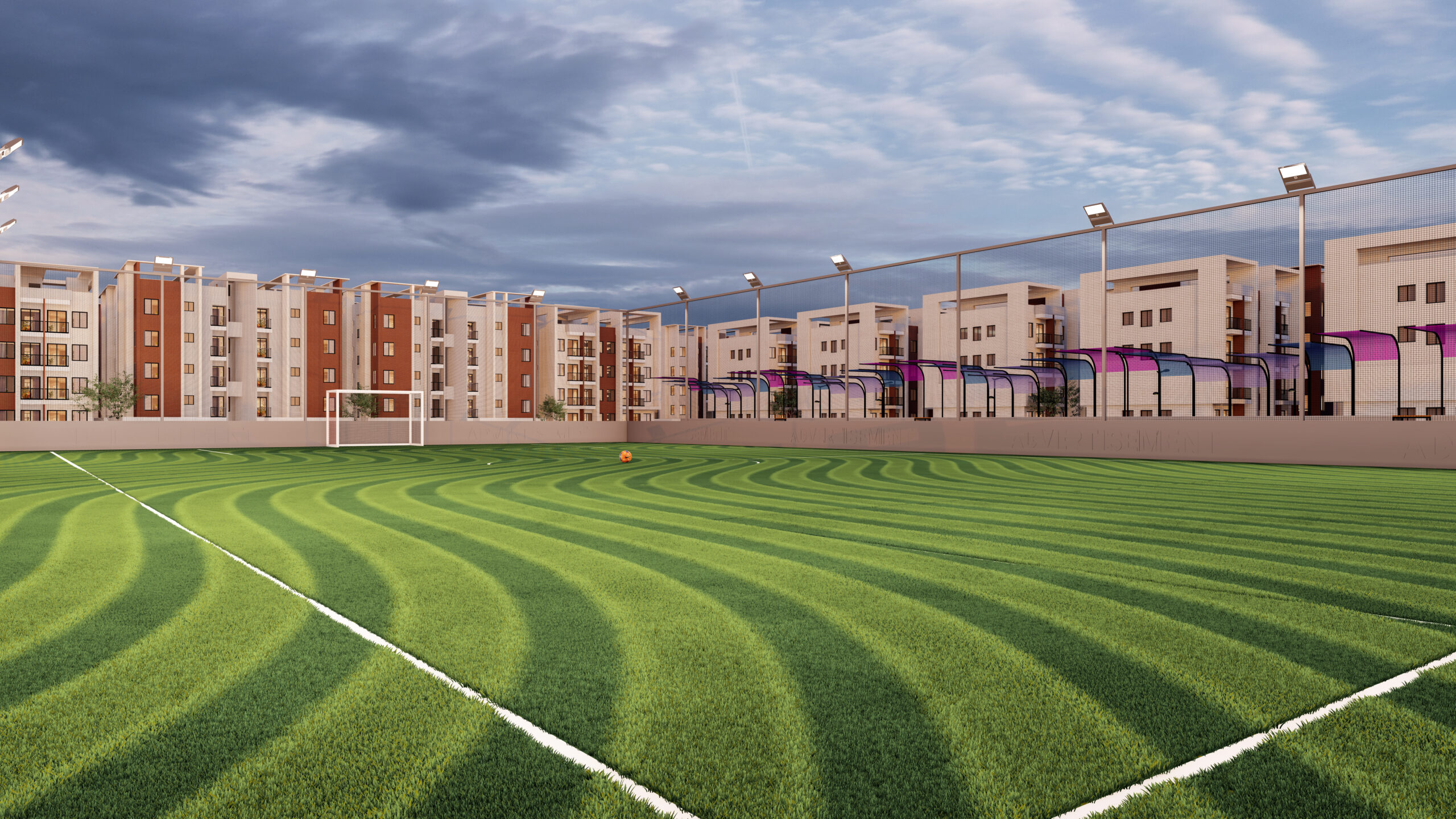Green soccer field with residential buildings